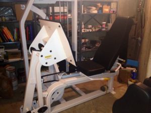 An exercise machine in a garage.