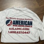 A white t shirt with the american logo on it.